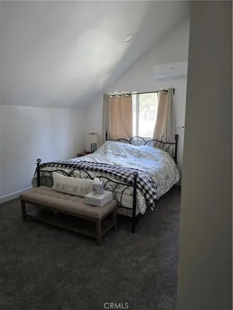 a bed room with furniture and flat screen tv