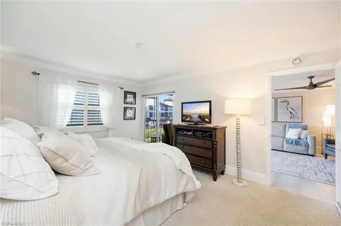 a bedroom with a bed and dresser with mirror