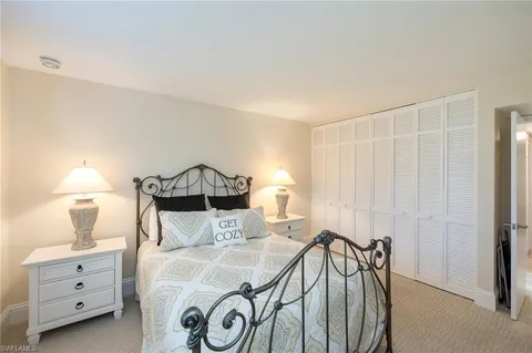 a bedroom with a bed and a table