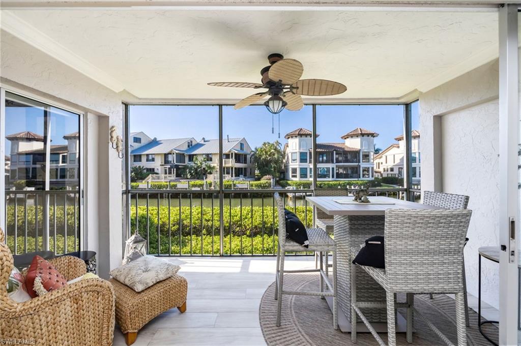 1200 Blue Point Avenue, Unit A2 Naples, FL 34102 - Photo 22 of 30 The screened balcony features a ceiling fan, providing comfort for outdoor living