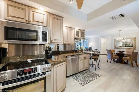 a kitchen with a stove cabinets and microwave