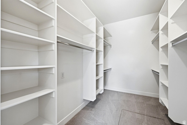 496 North Farmhouse Way, Unit 11 Midway, UT 84049 - Photo 24 of 50 Walk-in closet featuring white built-in shelving, multiple hanging rods, and grey carpet flooring