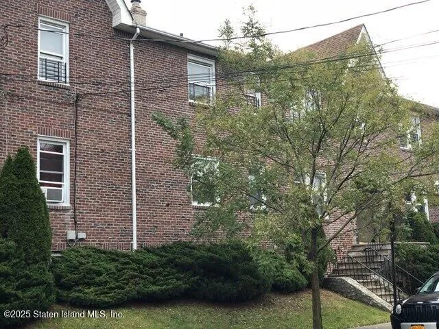 a view of a brick house with a yard