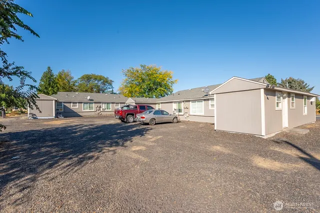 a car parked in front of white house