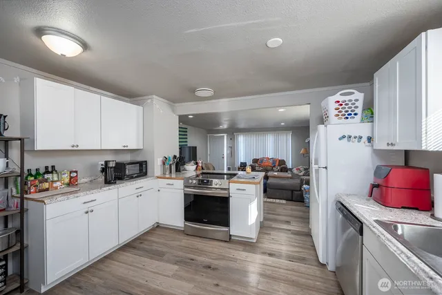 a kitchen with a stove a refrigerator and a refrigerator