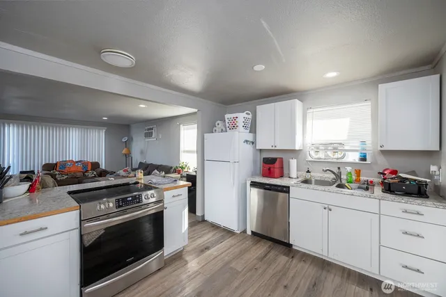 a kitchen with a white cabinets and white appliances