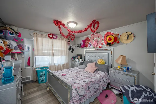 a bedroom with bed and window