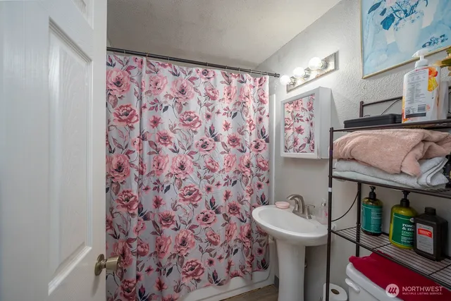 a bathroom with a sink toilet and shower