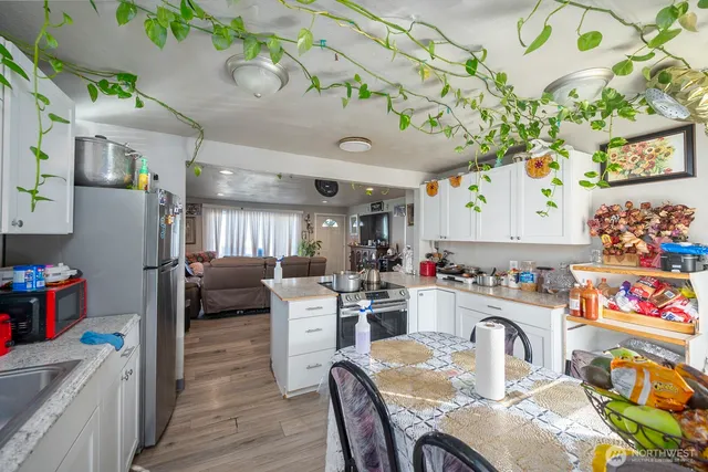a kitchen with a refrigerator and a dining table