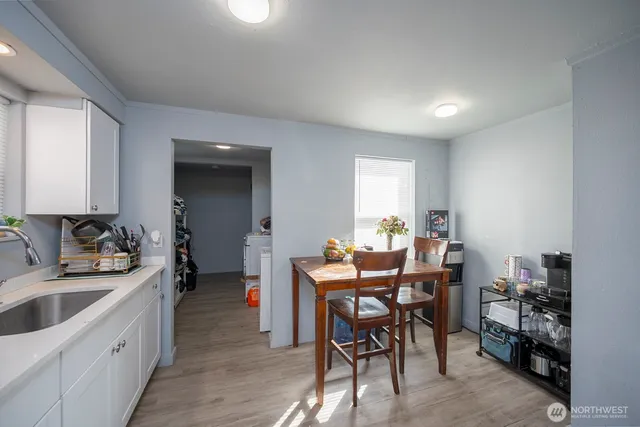 a view of a dining room with furniture and wooden floor