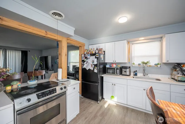 a kitchen with a stove a sink and a refrigerator