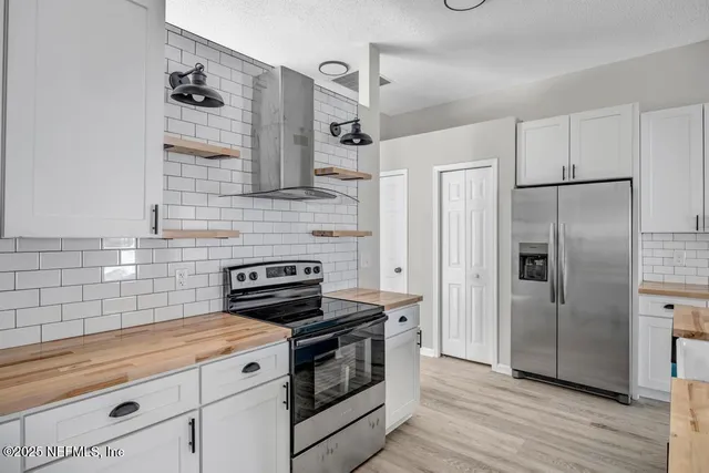 a kitchen with a stove and a refrigerator