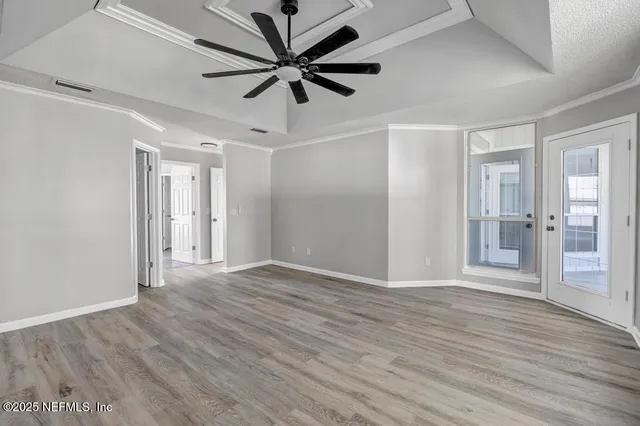 a view of a big room with wooden floor and a ceiling fan