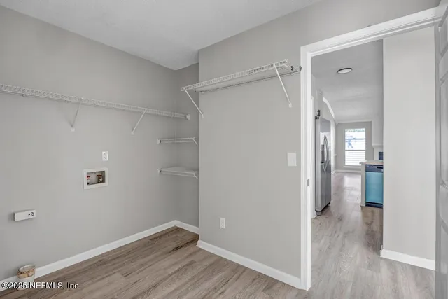a view of hallway with wooden floor