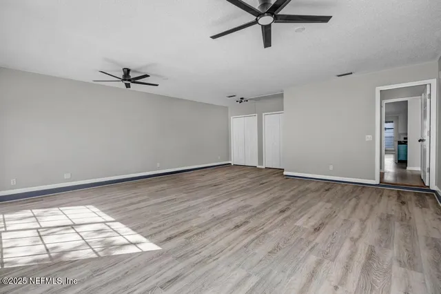 a view of a livingroom with a hardwood floor and a ceiling fan