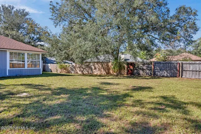 a view of a house with a yard and sitting area