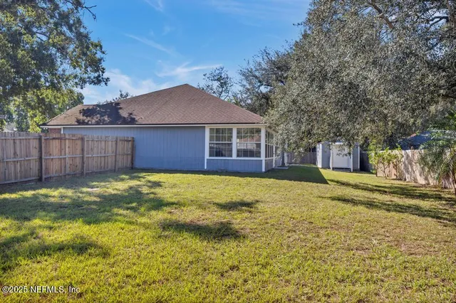 a view of a house with a yard and garage