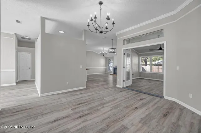 a view of a chandelier and wooden floor in a room