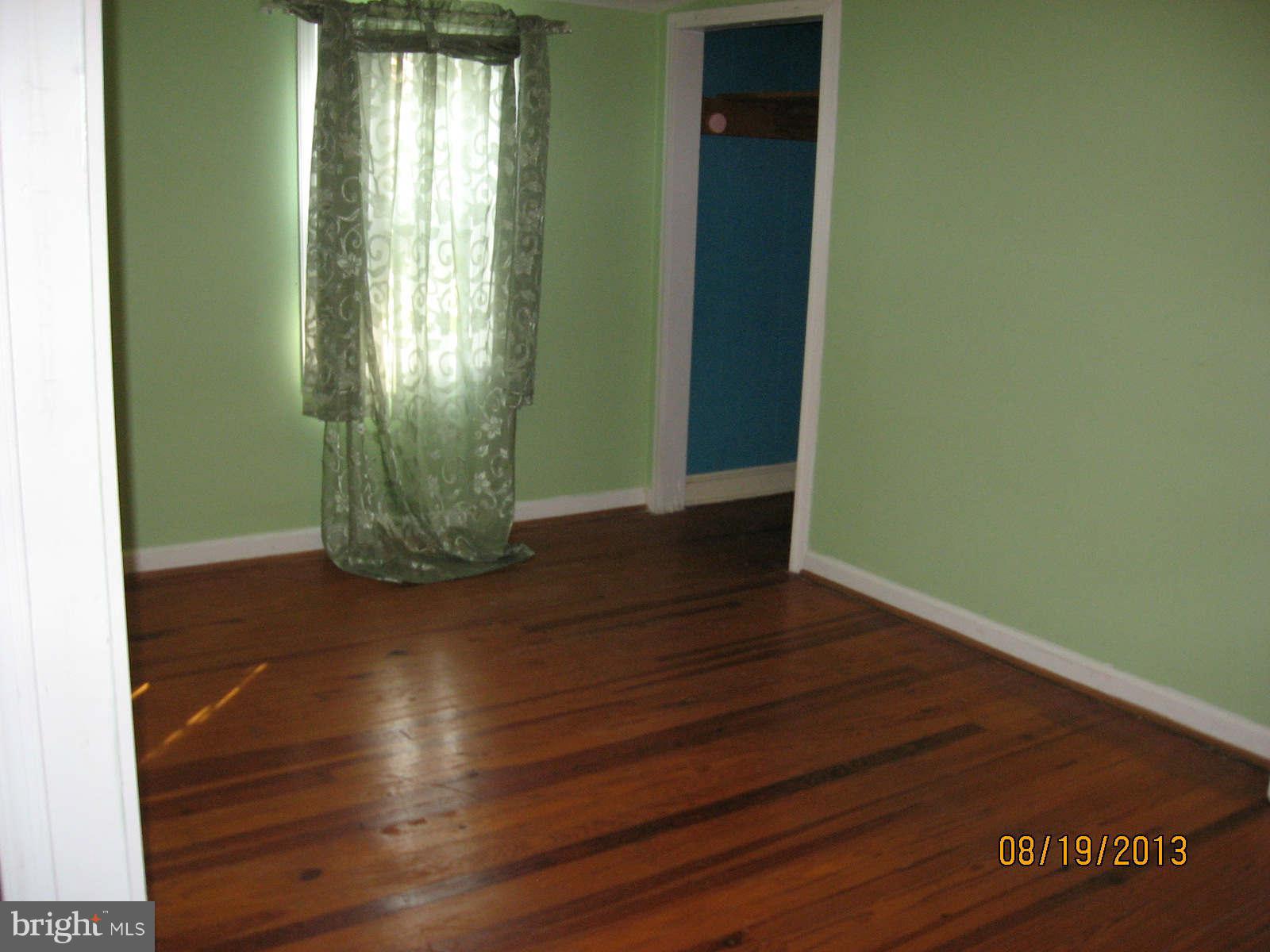 315 Bryants Nursery Road Silver Spring, MD 20905 - Photo 15 of 24 an empty room with wooden floor and windows