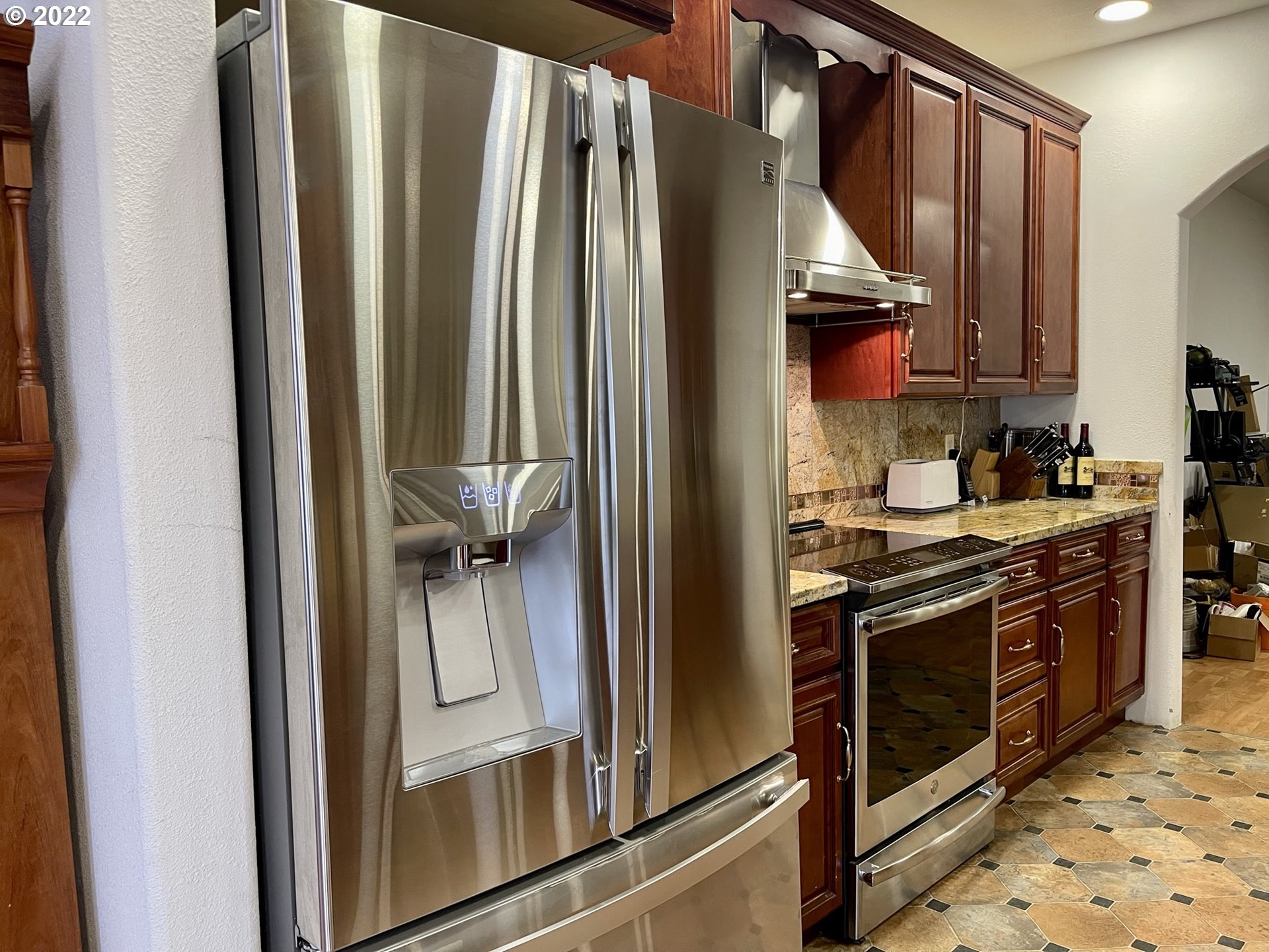 66325 North Bay Road North Bend, OR 97459 - Photo 13 of 31 a kitchen with stainless steel appliances granite countertop a refrigerator and a sink