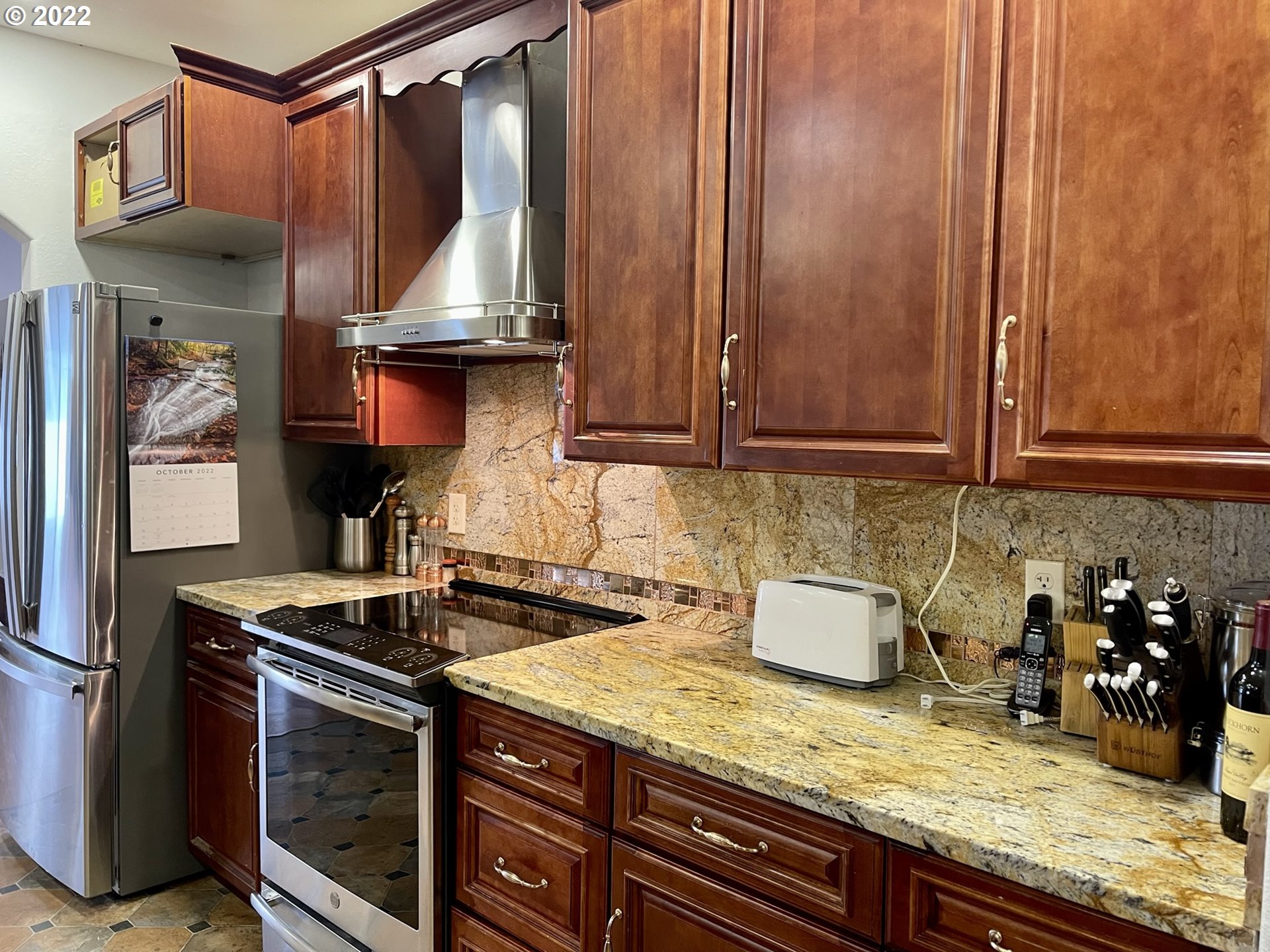 66325 North Bay Road North Bend, OR 97459 - Photo 16 of 31 a kitchen with stainless steel appliances granite countertop a sink stove and cabinets
