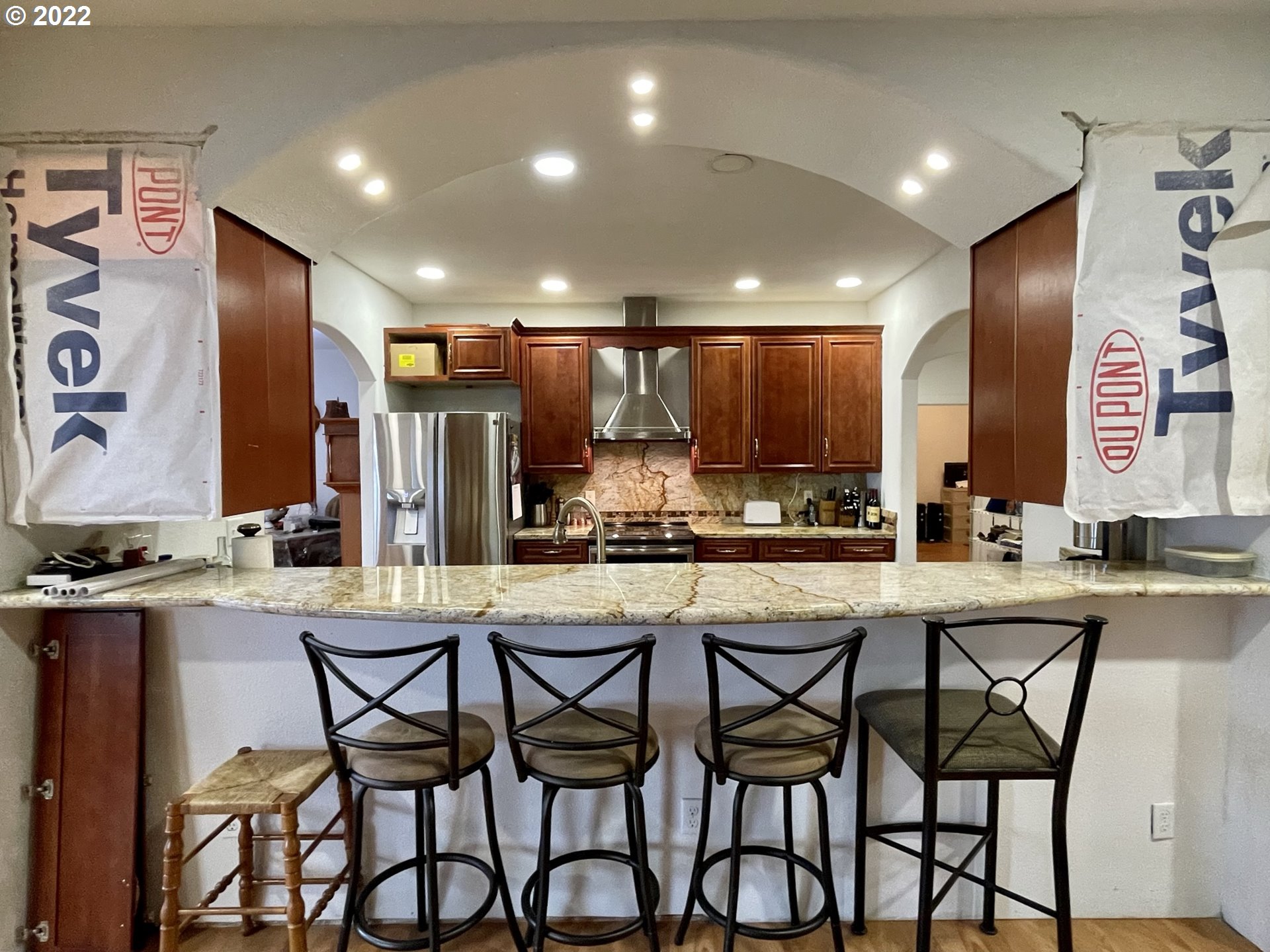 66325 North Bay Road North Bend, OR 97459 - Photo 18 of 31 a kitchen with stainless steel appliances kitchen island granite countertop a dining table chairs and white cabinets