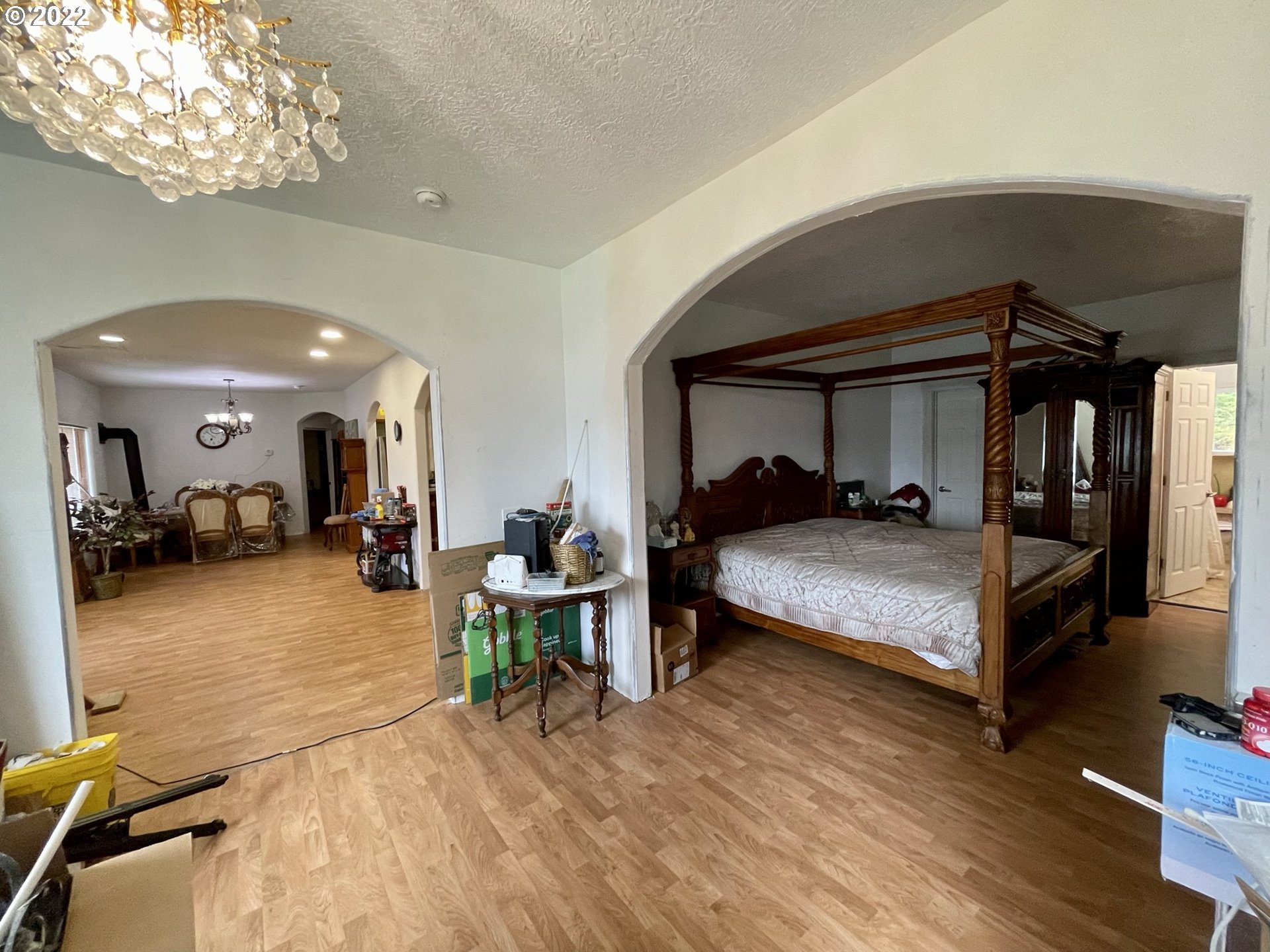 66325 North Bay Road North Bend, OR 97459 - Photo 20 of 31 a bedroom with furniture and a chandelier