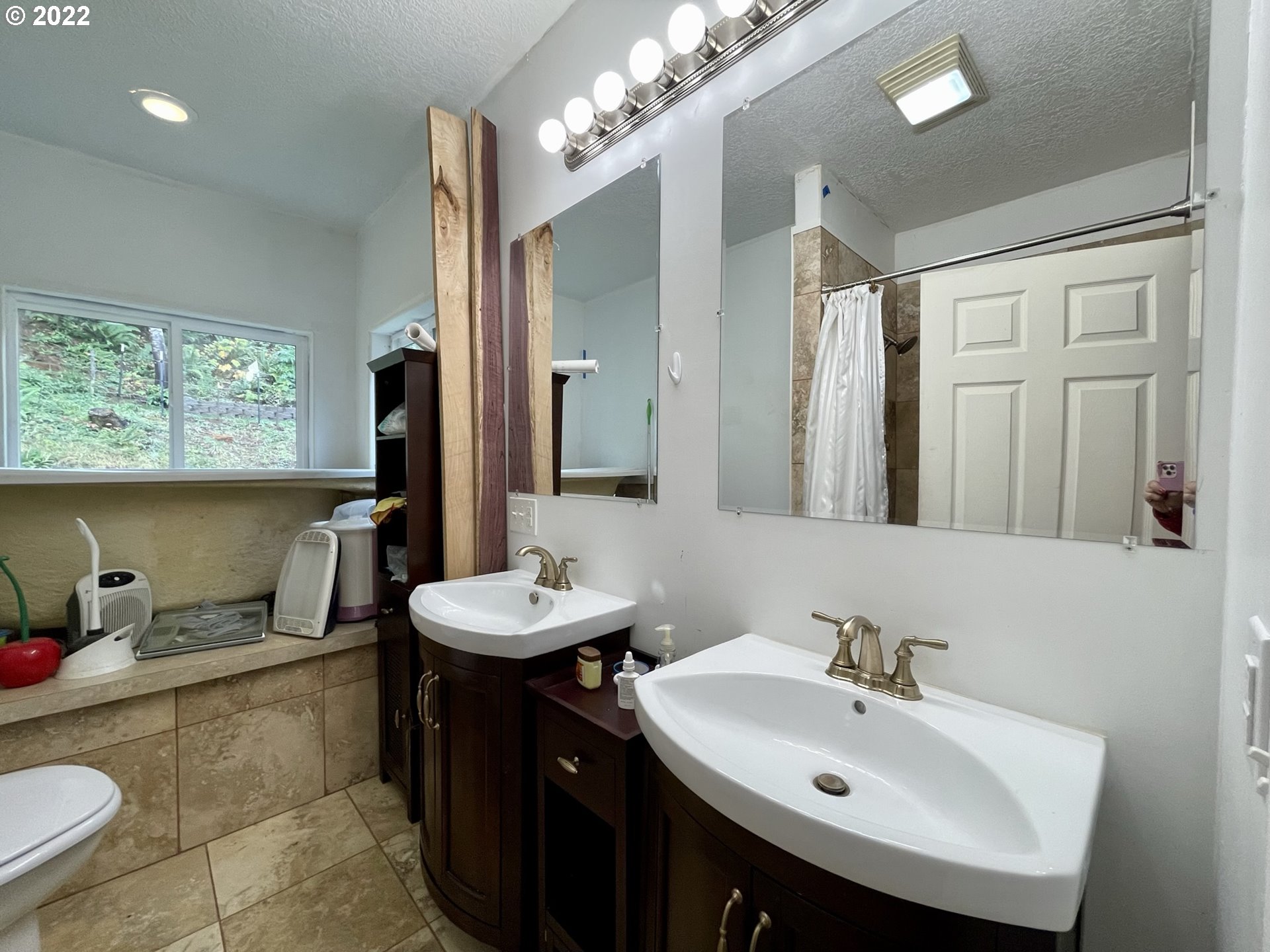 66325 North Bay Road North Bend, OR 97459 - Photo 22 of 31 a bathroom with a sink double vanity and a mirror