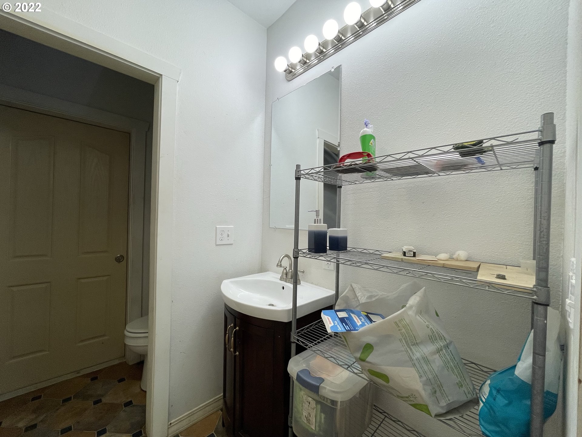 66325 North Bay Road North Bend, OR 97459 - Photo 26 of 31 a bathroom with a sink and a mirror