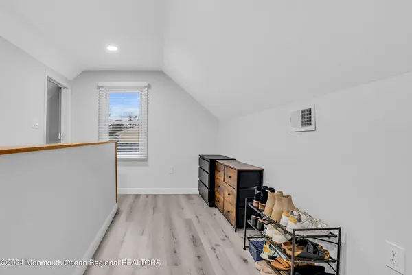 a view of a workspace with wooden floor