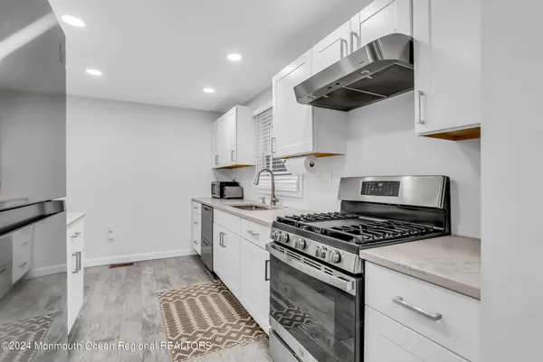 a kitchen with stainless steel appliances granite countertop a stove and a sink