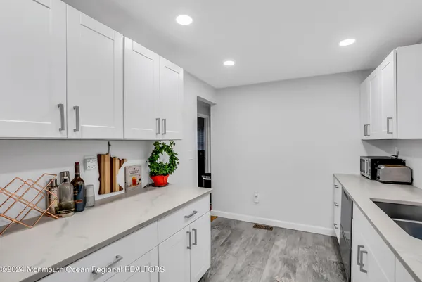 a kitchen with stainless steel appliances granite countertop a sink a stove and cabinets