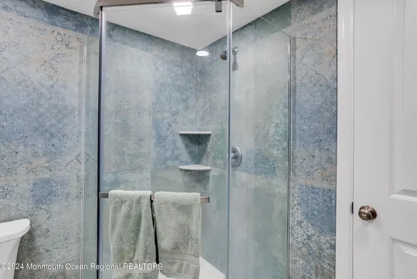 a bathroom with a shower and a sink