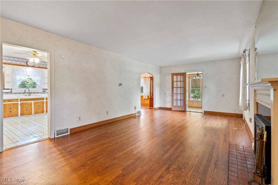 3550 Manchester Road Akron, OH 44319 - Photo 4 of 40 Unfurnished living room with ceiling fan, sink, a wealth of natural light, and hardwood / wood-style floors