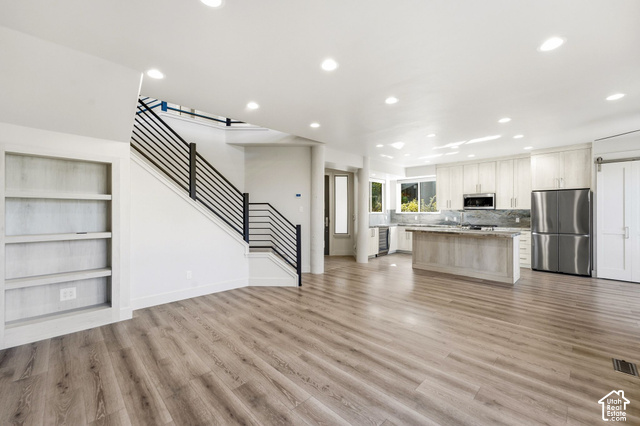 1067 Station Loop Road Park City, UT 84098 - Photo 15 of 38 Spacious interior featuring wood-finish flooring, recessed lighting, and a modern kitchen with stainless steel appliances