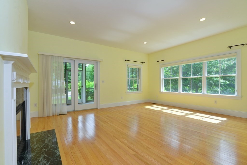 15 Hathaway Pond Circle, Unit 15 Rochester, MA 02770 - Photo 11 of 36 a view of an empty room with wooden floor and a window