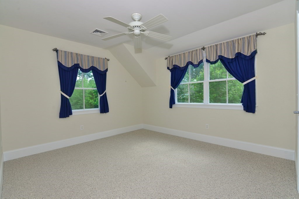 15 Hathaway Pond Circle, Unit 15 Rochester, MA 02770 - Photo 21 of 36 a view of a bedroom with window and a ceiling fan