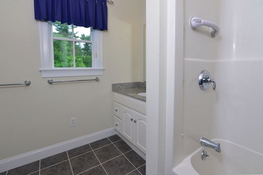 15 Hathaway Pond Circle, Unit 15 Rochester, MA 02770 - Photo 22 of 36 a bathroom with a granite countertop sink mirror and window