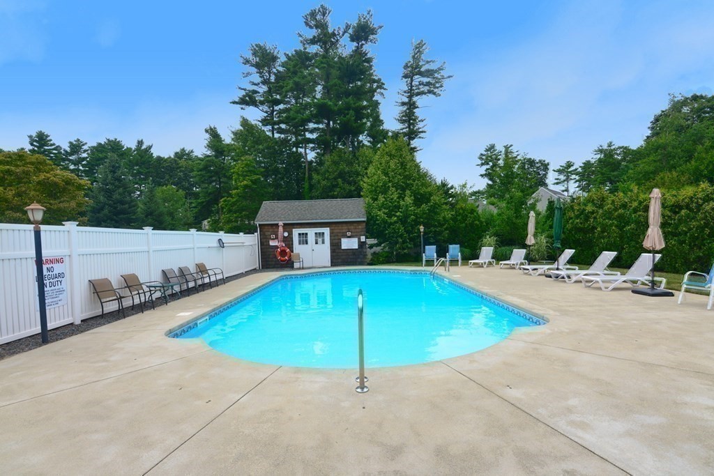 15 Hathaway Pond Circle, Unit 15 Rochester, MA 02770 - Photo 26 of 36 a swimming pool with outdoor seating and yard