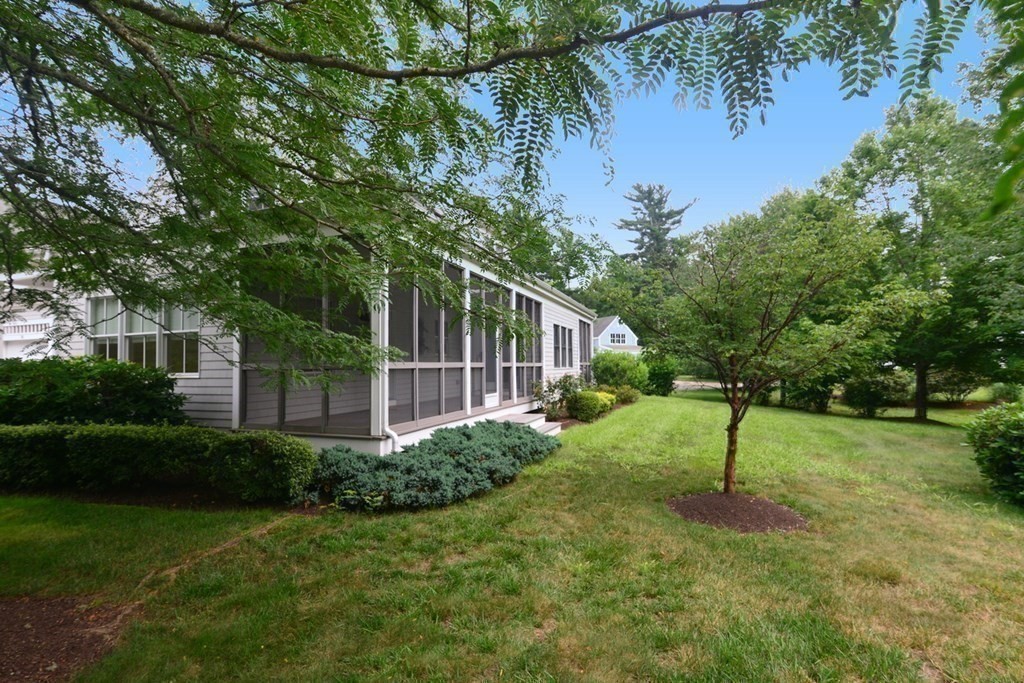 15 Hathaway Pond Circle, Unit 15 Rochester, MA 02770 - Photo 32 of 36 a view of a backyard with plants and a lake view