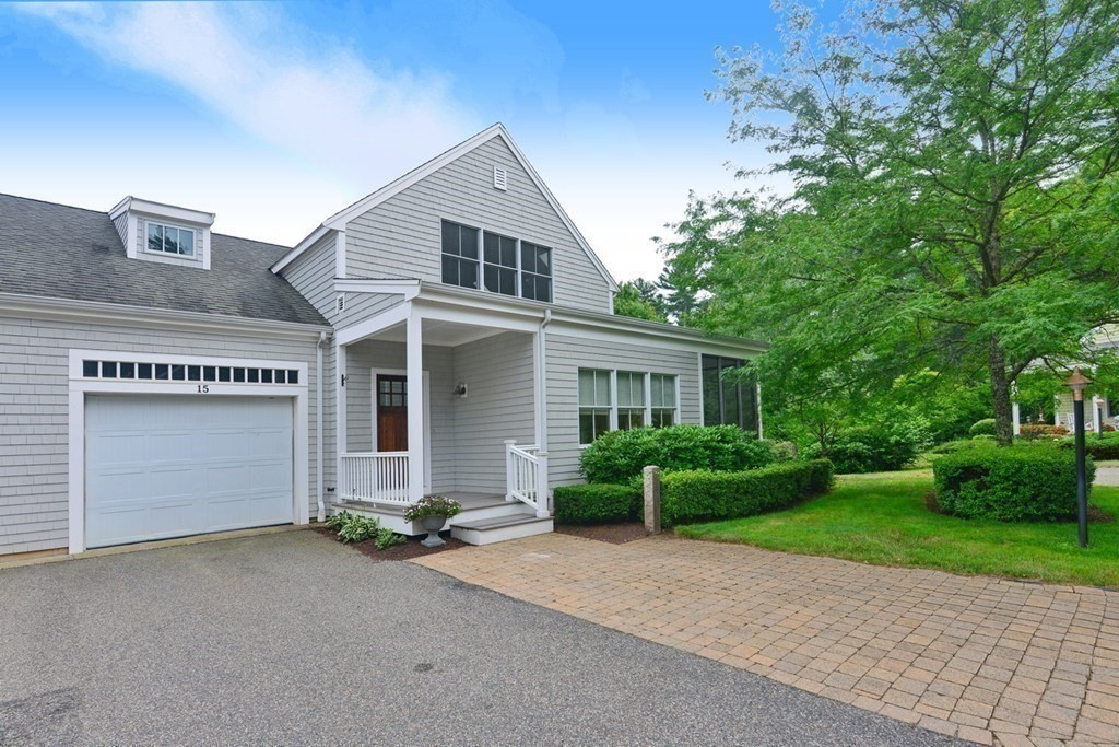 15 Hathaway Pond Circle, Unit 15 Rochester, MA 02770 - Photo 4 of 36 a front view of a house with a yard and garage