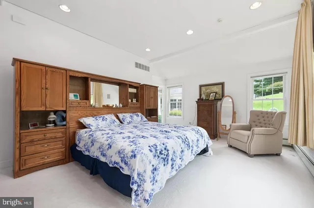 a bedroom with a large bed and a couch