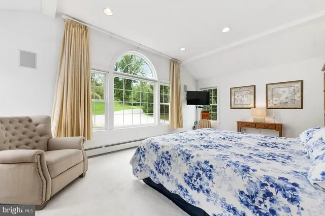 a bedroom with a large bed and a couch