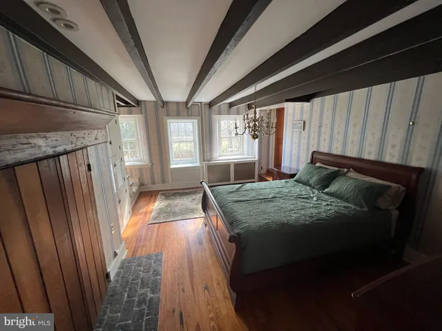 a bed sitting in a bedroom next to a window