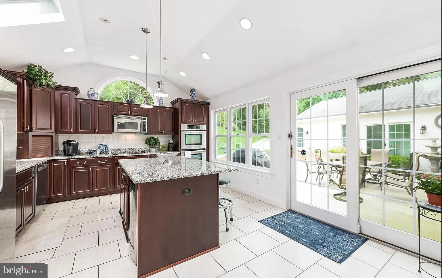 908 Lincoln Road Phoenixville, PA 19460 - Photo 26 of 26 a kitchen with kitchen island granite countertop a stove a sink and a refrigerator