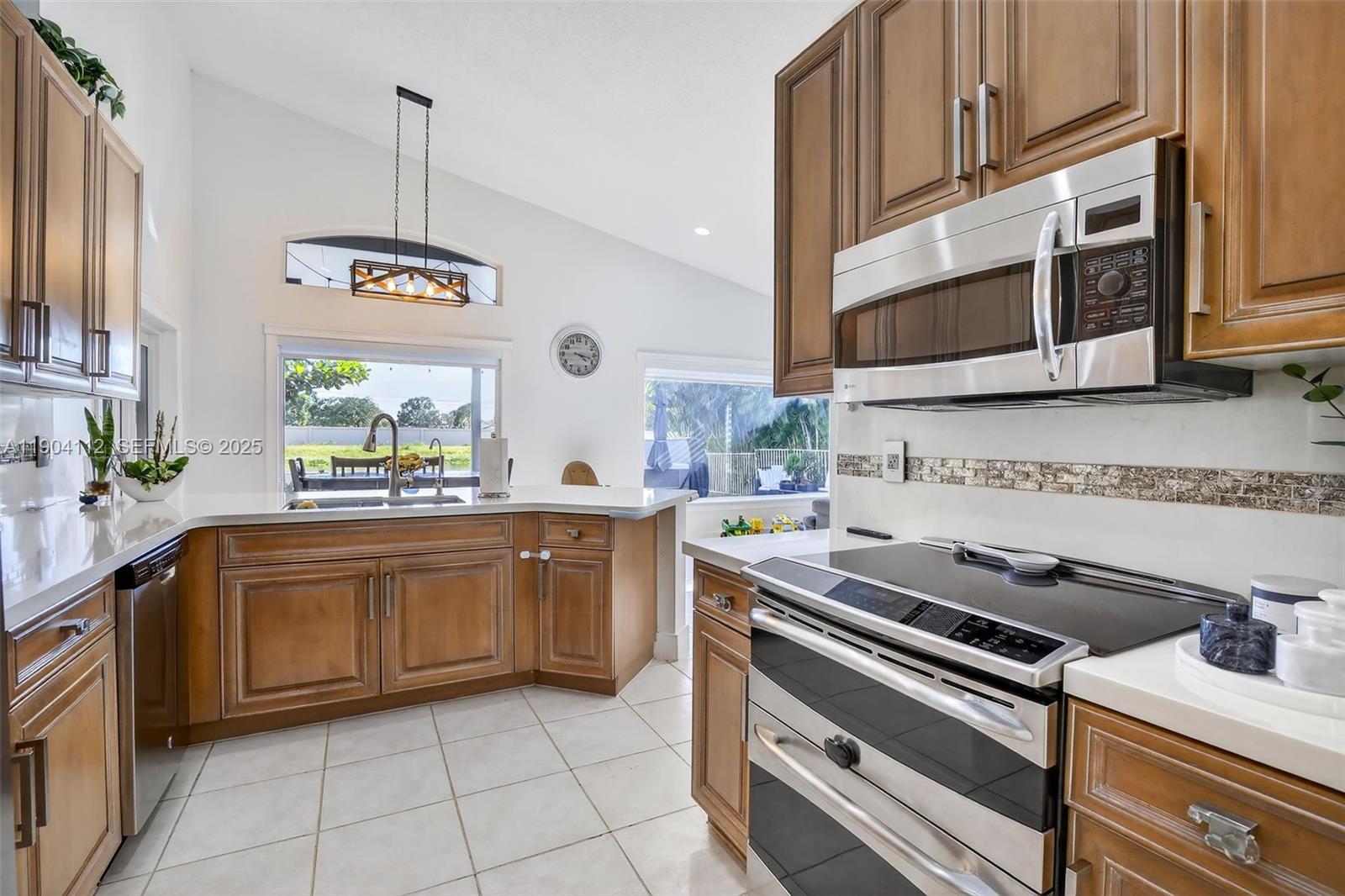 18950 Southwest 16th Street, Unit 1950 Pembroke Pines, FL 33029 - Photo 15 of 51 a kitchen with stainless steel appliances granite countertop a sink stove and cabinets