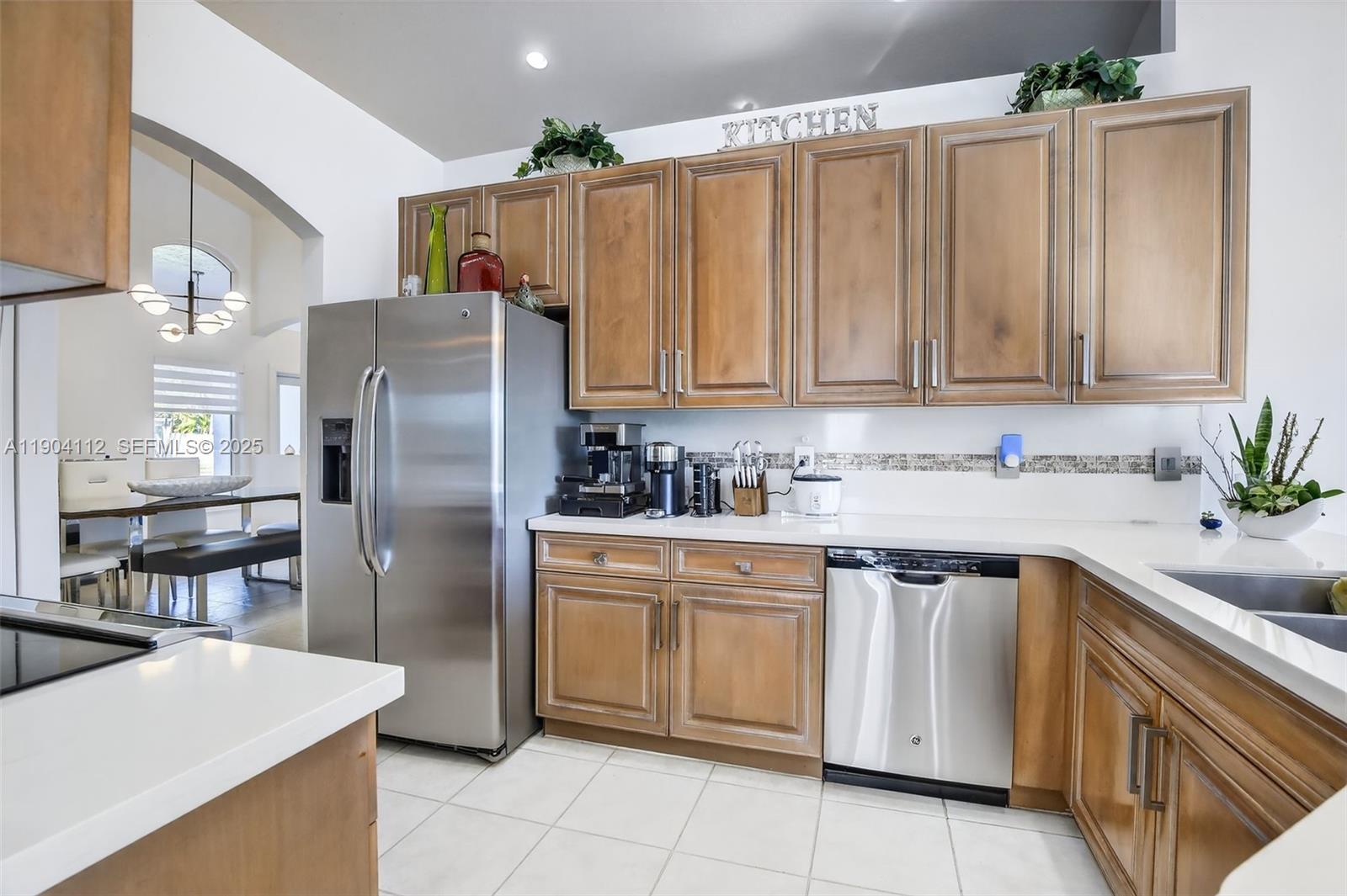 18950 Southwest 16th Street, Unit 1950 Pembroke Pines, FL 33029 - Photo 16 of 51 a kitchen with granite countertop a sink stainless steel appliances and cabinets
