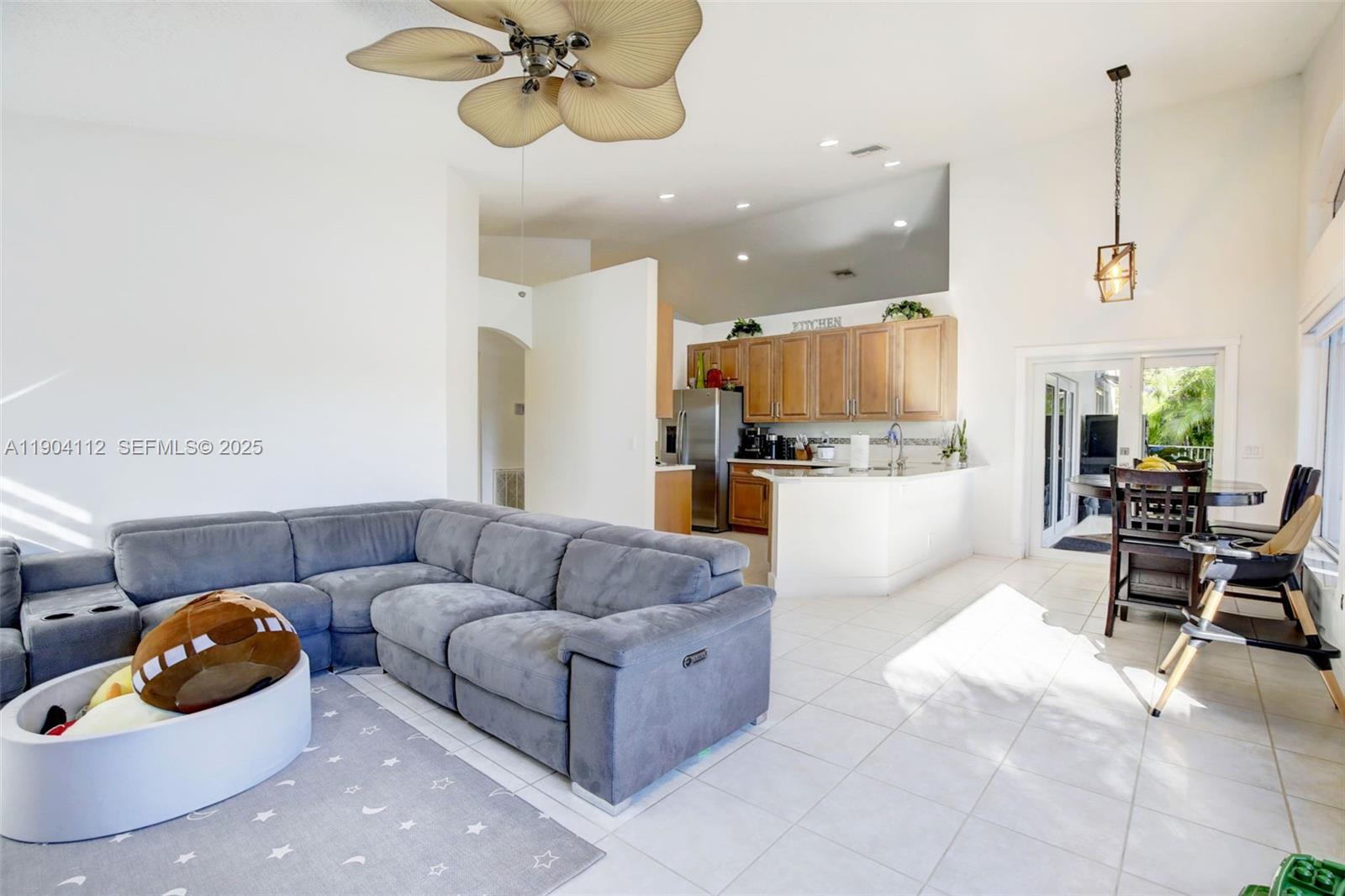 18950 Southwest 16th Street, Unit 1950 Pembroke Pines, FL 33029 - Photo 20 of 51 a living room with furniture and kitchen view