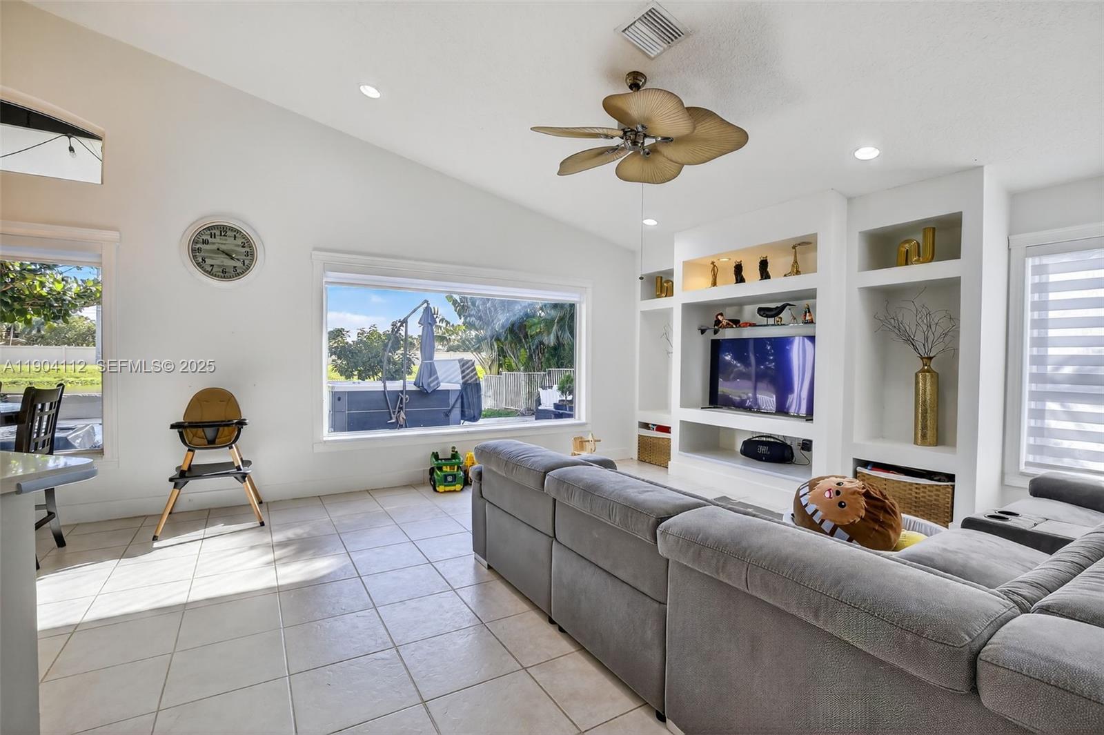 18950 Southwest 16th Street, Unit 1950 Pembroke Pines, FL 33029 - Photo 22 of 51 a living room with furniture and a large window