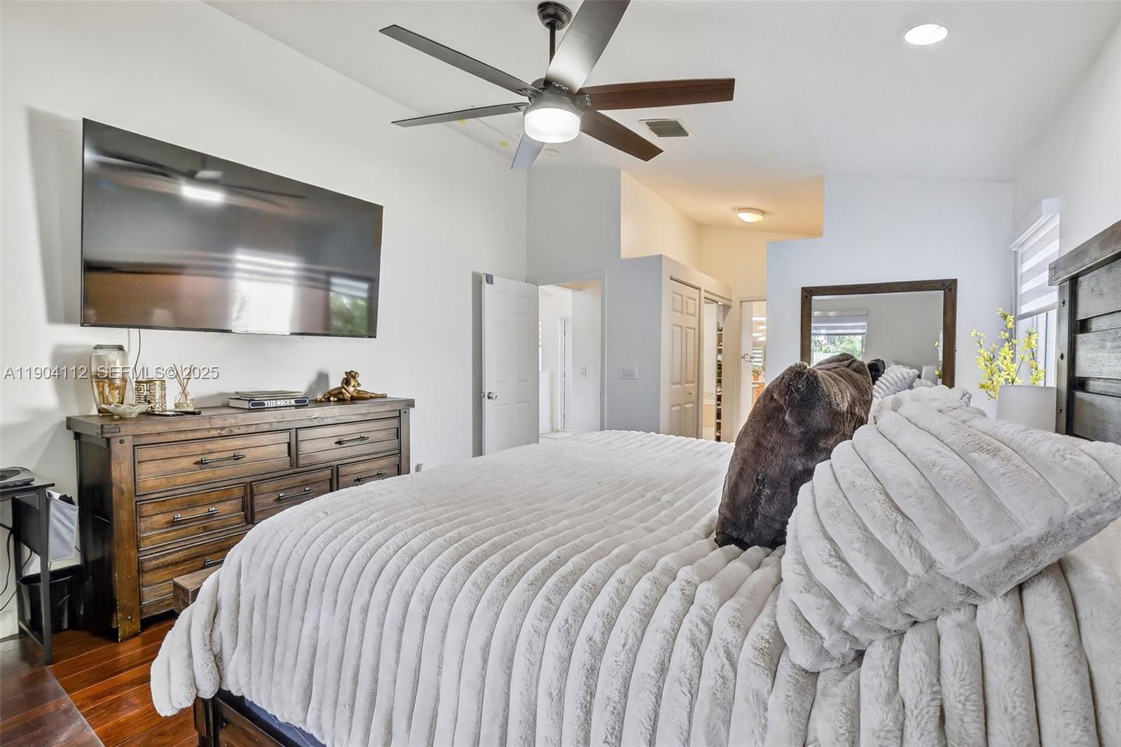 18950 Southwest 16th Street, Unit 1950 Pembroke Pines, FL 33029 - Photo 26 of 51 a bedroom with a bed and a flat screen tv
